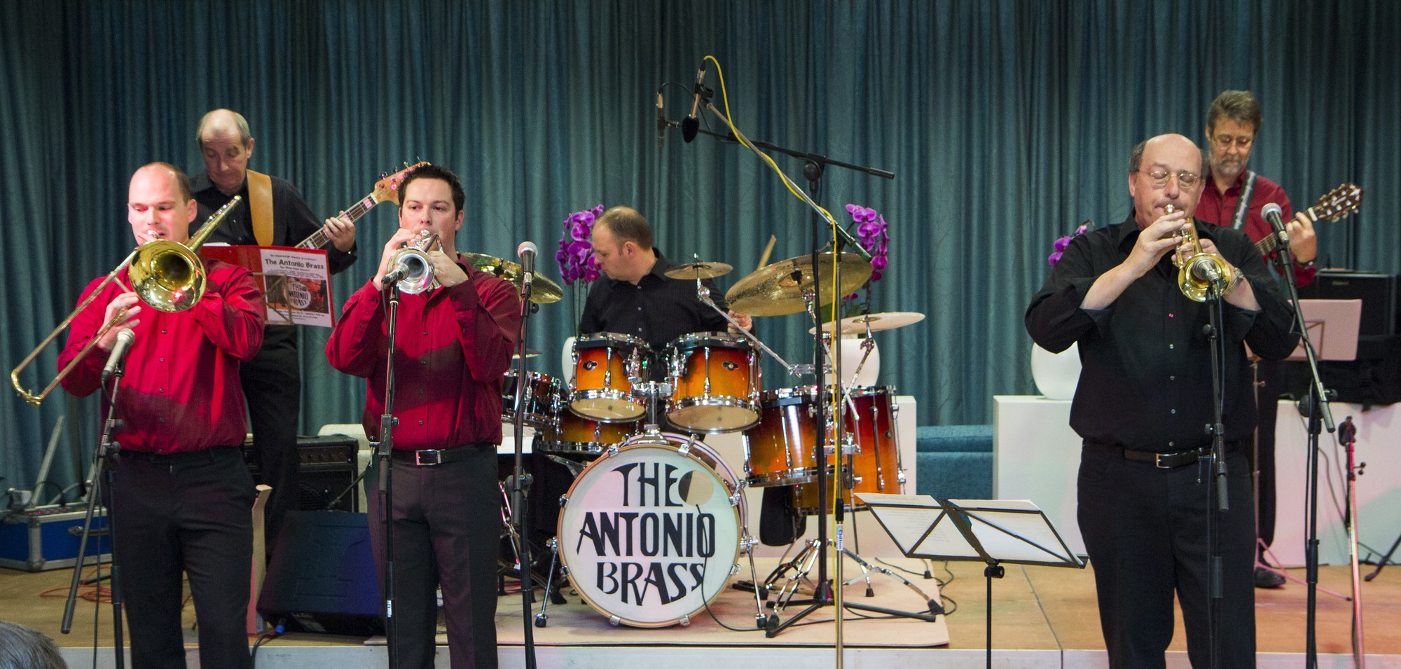 The Antonio Brass performing live on stage — trumpets, trombone and drums